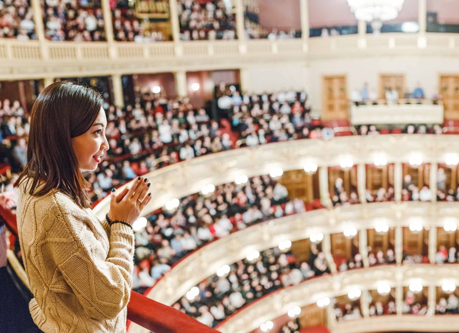 A woman in the theater watches the performance